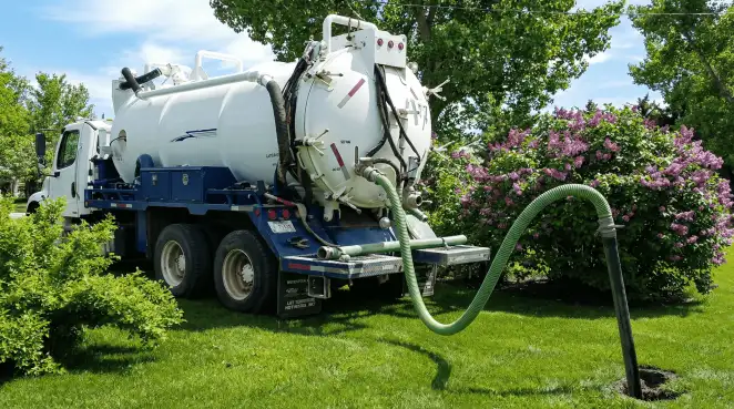 Professional vacuum truck performing residential drainage and septic maintenance in Wichita, KS