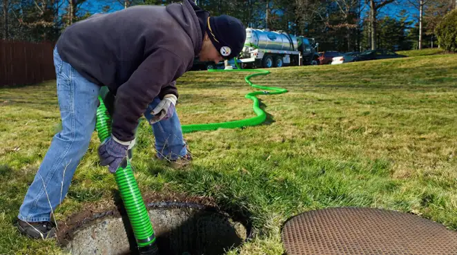 Service technician performing residential septic pumping and drainage maintenance in Wichita, KS